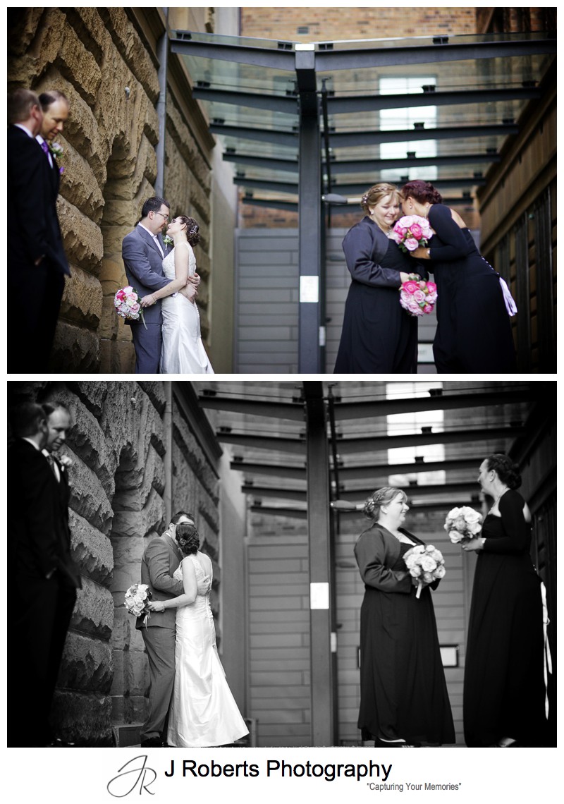 Bride and groom kissing with bridal party around - sydney wedding photography 